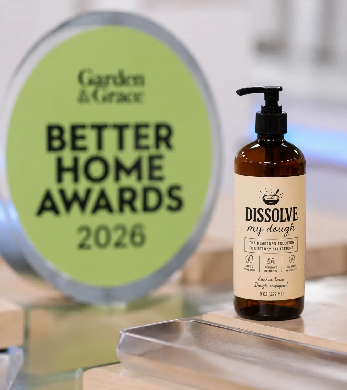 The Dissolve My Dough bottle photographed beside the Garden & Grace Better Home Awards 2026 trophy